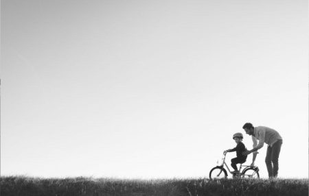 Child learning to ride bike