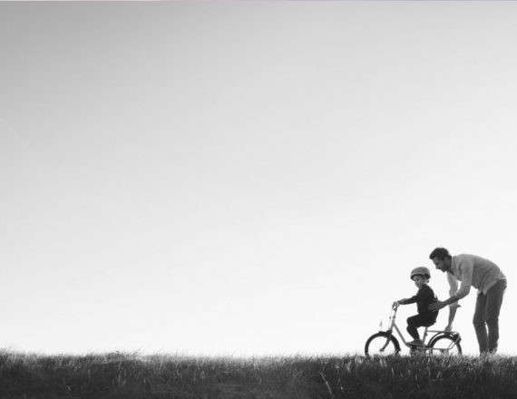 Child learning to ride bike