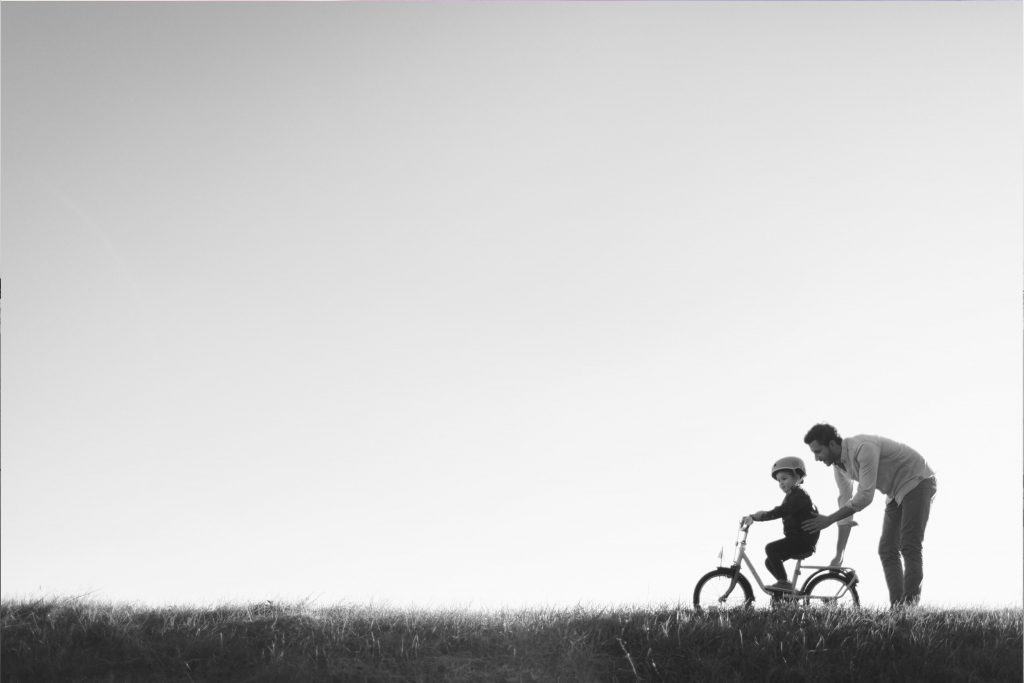 Child learning to ride bike